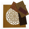 Wood veneer sheets with intricate geometric inlay patterns cut for a telephone gossip bench project.