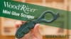 Hand holding green WoodRiver Mini Glue Scraper tool for cleaning glue lines in woodworking