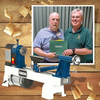 Two men holding a certificate stand behind a Rikon wood lathe with wood shavings scattered around.
