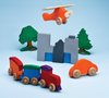 Colorful handmade wooden toys including a train, car, airplane, trees, and cityscape blocks on blue background.