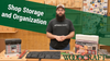 Woodworker standing behind organized shop storage boxes and tool rolls in workshop setting