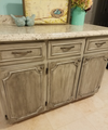 Distressed kitchen cabinet doors and drawers with decorative raised panel molding and metal handles