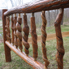 Rustic log railing with twisted spindles made from natural tree branches outdoors