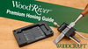 WoodRiver Premium Honing Guide with sharpening stone and wooden-handled chisel on workbench
