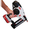 Hand holding a cordless 20V lithium-ion finish nailer with angled magazine and depth adjustment.