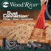 Hand using red dust collection attachment to clean wood shavings from hardwood surface with various black dust collection