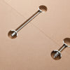 Cross dowel and bolt fasteners installed in particleboard for knock-down furniture joinery.